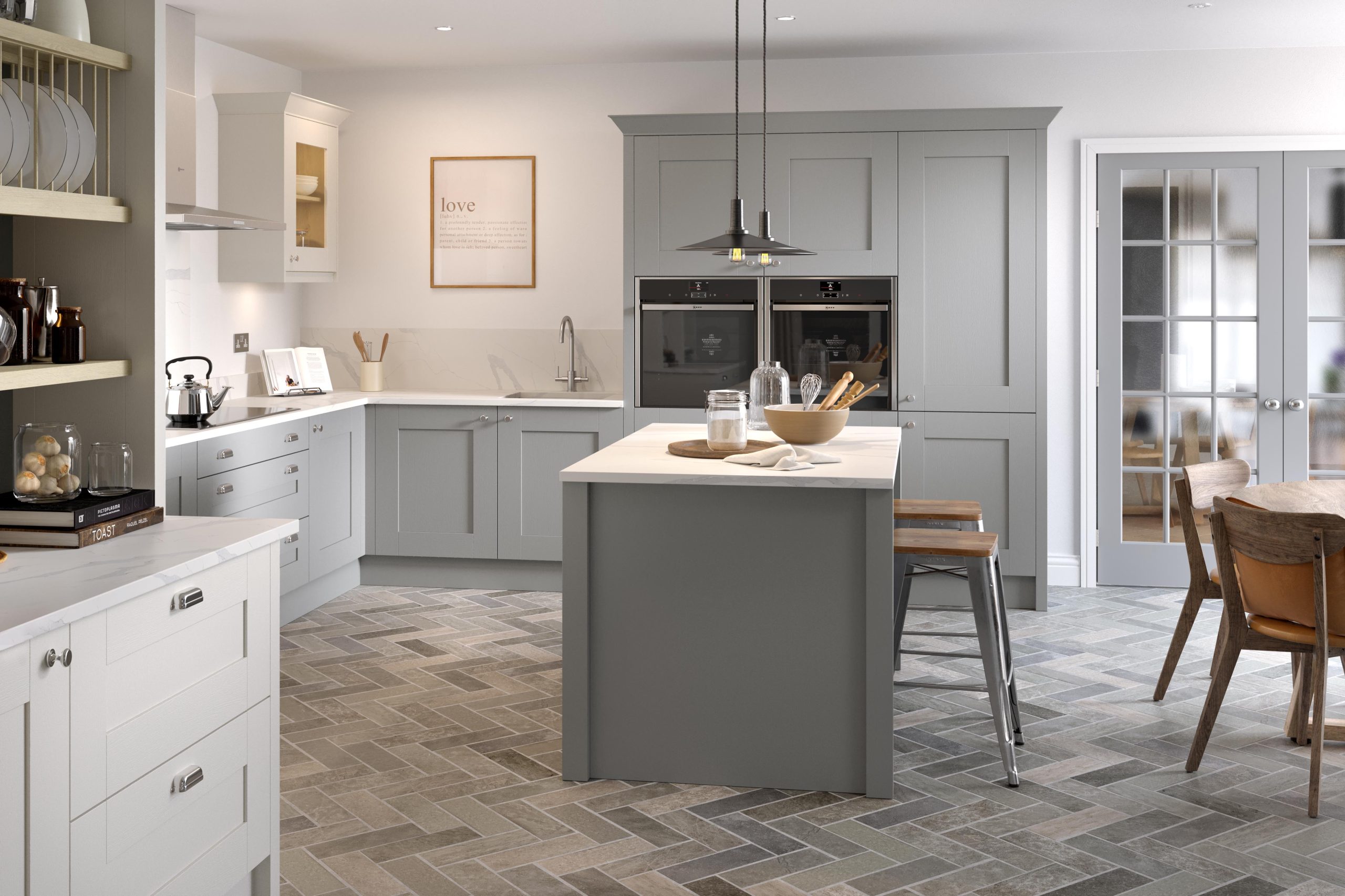 a grey kitchen with a breakfast island and stone floor tiles