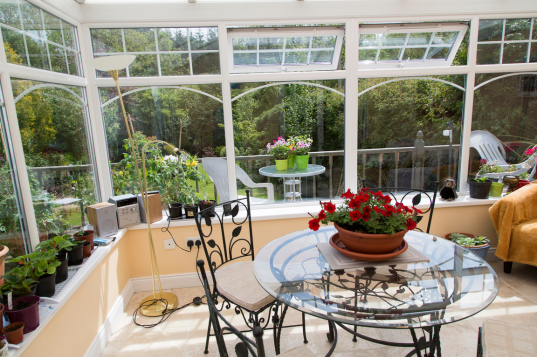 conservatory with a small glass table with flowers on